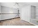 Upstairs loft with laminate floors, white railing, and a built-in shelving unit at 4406 Barcelona Ln., Little River, SC 29566