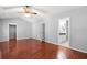Sunlit primary bedroom with laminate floors, doorways to closet and bathroom at 4406 Barcelona Ln., Little River, SC 29566