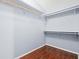 Spacious walk-in closet with laminate flooring and ample shelving for organization at 4406 Barcelona Ln., Little River, SC 29566