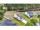 Aerial view of a home featuring well-manicured lawns, landscaping, and an asphalt roof at 4603 East Walkerton Rd., Myrtle Beach, SC 29579