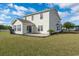 Spacious backyard with patio, grassy area, palm tree, and blue sky at 4603 East Walkerton Rd., Myrtle Beach, SC 29579