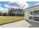 Open backyard patio with a sliding glass door entry and view of landscaped back lawn at 4603 East Walkerton Rd., Myrtle Beach, SC 29579