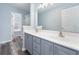 Stylish bathroom featuring double sinks, a large mirror, and wood look floors at 4603 East Walkerton Rd., Myrtle Beach, SC 29579