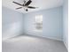 A bright bedroom with a ceiling fan, neutral carpet, and a window at 4603 East Walkerton Rd., Myrtle Beach, SC 29579