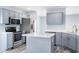 Spacious kitchen featuring stainless steel appliances, an island and light blue cabinetry at 4603 East Walkerton Rd., Myrtle Beach, SC 29579