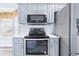 Modern kitchen with stainless steel appliances and light blue cabinetry at 4603 East Walkerton Rd., Myrtle Beach, SC 29579