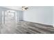 Spacious living area boasts laminate floors, soft blue walls, arched doorway, abundant natural light, and ceiling fan at 4603 East Walkerton Rd., Myrtle Beach, SC 29579