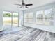 Bright living room features laminate floors, large windows, and a sliding glass door leading to the outdoor space at 4603 East Walkerton Rd., Myrtle Beach, SC 29579