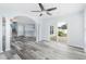 Open-concept living area featuring laminate floors, blue walls, arched doorway, and sliding glass doors to the backyard at 4603 East Walkerton Rd., Myrtle Beach, SC 29579