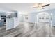 Bright and airy living space featuring gray laminate flooring, neutral paint, and seamless transition to dining and kitchen area at 4603 East Walkerton Rd., Myrtle Beach, SC 29579