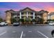 Condominium complex featuring architectural details and well-maintained landscaping at 4633 Lightkeepers Way # 5-F, Little River, SC 29566