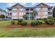 Beautiful condo building with landscaping and water view at 4633 Lightkeepers Way # 5-F, Little River, SC 29566