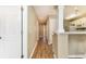View of a hallway with wood floors leading to other rooms and kitchen area at 4633 Lightkeepers Way # 5-F, Little River, SC 29566