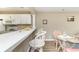 Bright kitchen featuring white cabinets, a breakfast bar with seating, and an adjacent dining area at 4633 Lightkeepers Way # 5-F, Little River, SC 29566