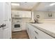 Well-equipped kitchen with white appliances, sleek countertops, and ample cabinet space for efficient meal preparation at 4633 Lightkeepers Way # 5-F, Little River, SC 29566