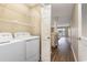 The laundry room includes a washer, dryer, and shelving at 4633 Lightkeepers Way # 5-F, Little River, SC 29566
