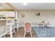 Cozy living room with wicker chairs, a glass table, and wood floors at 4633 Lightkeepers Way # 5-F, Little River, SC 29566