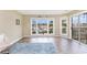 Bright living room showcases marina views from large windows and sliding glass door at 4633 Lightkeepers Way # 5-F, Little River, SC 29566