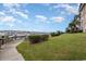 Scenic view of the marina from the lawn, featuring lush greenery and a wooden boardwalk at 4633 Lightkeepers Way # 5-F, Little River, SC 29566