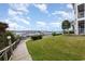 Scenic view of the marina from the lawn, featuring lush greenery and a wooden boardwalk at 4633 Lightkeepers Way # 5-F, Little River, SC 29566