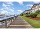 Wooden boardwalk running alongside a marina with boat slips and condo buildings at 4633 Lightkeepers Way # 5-F, Little River, SC 29566