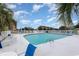 Community swimming pool with ample seating and lounge chairs surrounded by palm trees at 4633 Lightkeepers Way # 5-F, Little River, SC 29566
