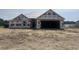 Exterior of a new construction single-Gathering home featuring a two-car garage and covered entry at 475 Highway 348, Loris, SC 29569