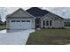 Charming single-story home featuring a two-car garage, manicured lawn, and inviting curb appeal at 475 Highway 348, Loris, SC 29569