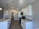 Modern kitchen boasts stainless steel appliances, marble countertops, and sleek white cabinetry at 475 Highway 348, Loris, SC 29569