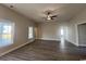 Bright living room features wood-look flooring, neutral paint, a ceiling fan, and many windows for natural light at 475 Highway 348, Loris, SC 29569