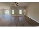 Spacious living room with hardwood floors, ceiling fan, and bright natural light from the windows at 475 Highway 348, Loris, SC 29569