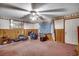 Cozy bedroom with paneled walls, a ceiling fan, and a window covered by sheer curtains at 4810 Circle Dr., Loris, SC 29569
