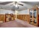 Spacious bedroom area with wood paneling, displaying vintage cabinetry, and a neutral color scheme at 4810 Circle Dr., Loris, SC 29569