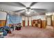 A classic bedroom featuring paneled walls, a ceiling fan, and a window with a sheer curtain at 4810 Circle Dr., Loris, SC 29569