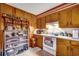 Functional kitchen with wooden cabinets, a white oven range, and open shelving for additional storage at 4810 Circle Dr., Loris, SC 29569
