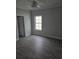 Bedroom with light gray walls, vinyl flooring, and window allowing natural light at 4823 Riverside Dr., North Myrtle Beach, SC 29582