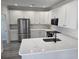Bright, modern kitchen with white cabinets, stainless steel appliances, and quartz countertops at 4823 Riverside Dr., North Myrtle Beach, SC 29582