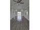 Expansive open-concept living space with wood floors, recessed lights, and sliding glass doors to a deck at 4823 Riverside Dr., North Myrtle Beach, SC 29582
