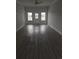 Spacious living room with hardwood flooring, lots of natural light, and modern ceiling fan at 4823 Riverside Dr., North Myrtle Beach, SC 29582