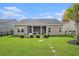 Manicured backyard with patio, lush lawn, and privacy fencing at 505 Joy Way Ct., Longs, SC 29568