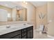 A bathroom featuring a double sink vanity, toilet, and a framed mirror with a shower in the background at 505 Joy Way Ct., Longs, SC 29568