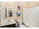 Bright bathroom featuring a vanity, toilet, and bathtub with tiled accents at 505 Joy Way Ct., Longs, SC 29568