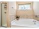 A bathroom with a walk-in shower and soaking tub and a small window with a shelf at 505 Joy Way Ct., Longs, SC 29568