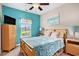 Bedroom featuring a window view, closet, and wall-mounted TV, with an artist painting on the wall at 505 Joy Way Ct., Longs, SC 29568
