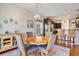 Elegant dining room with a round table and seamless flow into the adjacent, open kitchen space at 505 Joy Way Ct., Longs, SC 29568