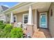 Inviting front porch with comfortable seating, brick accents, and a secure KTC security system sign at 505 Joy Way Ct., Longs, SC 29568