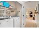 A laundry room with Maytag washer and dryer and wire shelving, located near a doorway at 505 Joy Way Ct., Longs, SC 29568