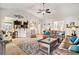 Bright and open living room featuring a leather sofa and seamless flow into the adjacent kitchen at 505 Joy Way Ct., Longs, SC 29568