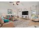 Cozy living room featuring a comfortable leather sofa, neutral rug, and bright natural light at 505 Joy Way Ct., Longs, SC 29568