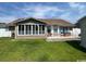 Relaxing back exterior with screened in porch, patio and well-manicured lawn providing ample outdoor living space at 550 Bridgeport Dr., Myrtle Beach, SC 29577